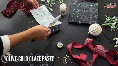 Eine Frau schabloniert einen schwarzen Keilrahmen mit pentart Glaze Paste